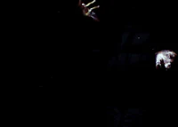 a man in a dark room with his hands out